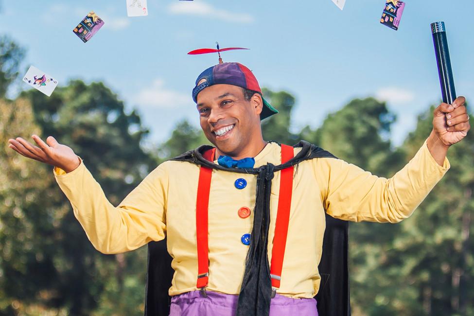 Tommy the magician with want and cards