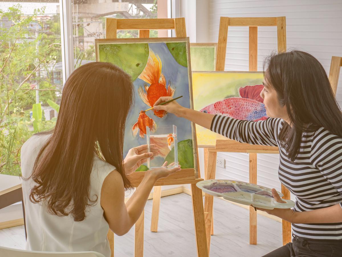 2 Adults Painting a Canvas