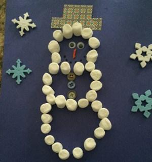 snowman shape out of mini marshmallows with winter decor