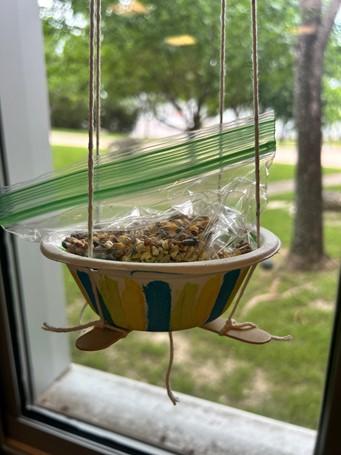 bowl with sticks and bird food for bird feeder
