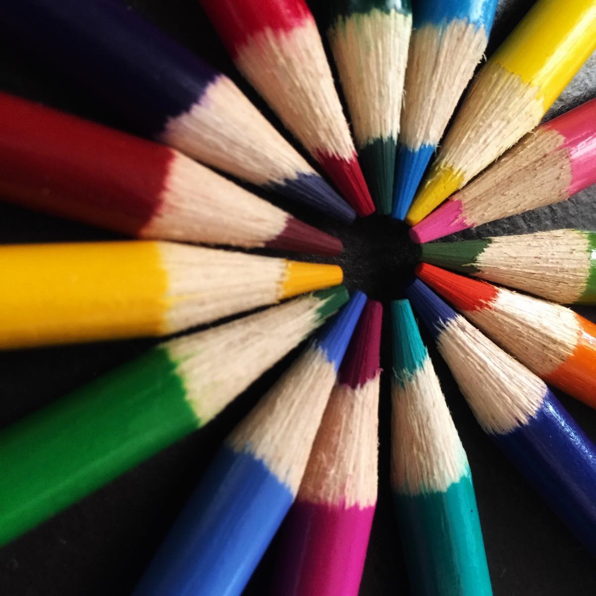 a circle of multi-colored sharpened colored pencils