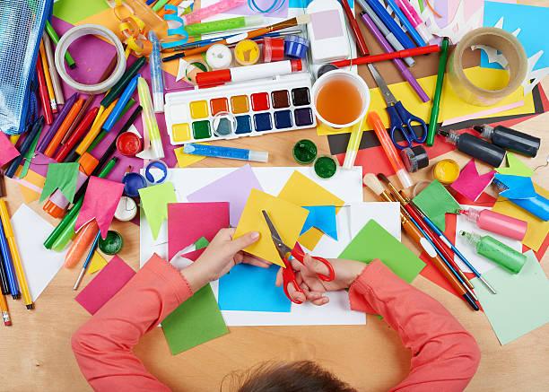 Kid with various art supplies 