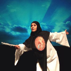 Actress dressed in black and white with blue and teal backdrop