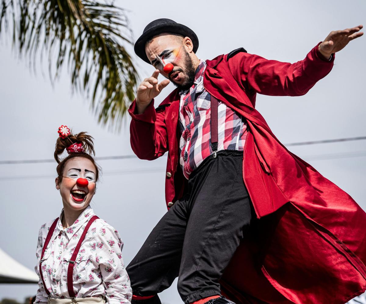 two people with simple clown make up and red noses