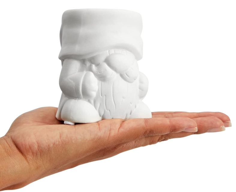 hand holding a small white planter shaped like a gnome