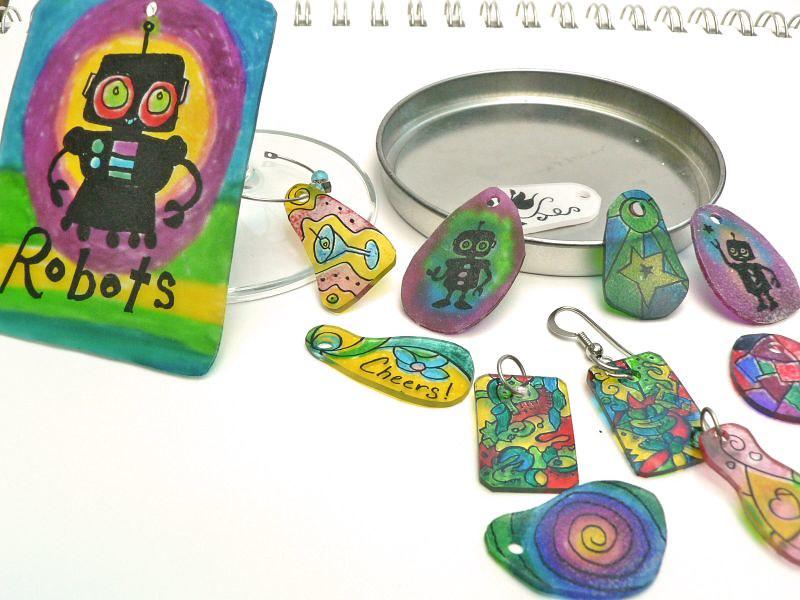 Several different colorful images are drawn on shrink plastic and cut out.