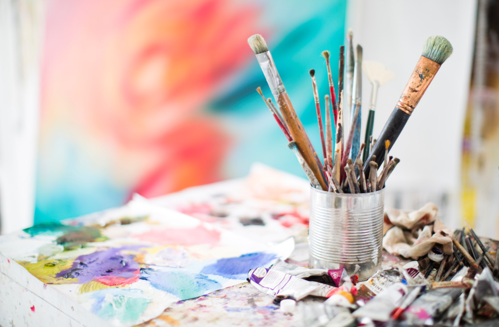 tin can with paintbrushes, watercolor background